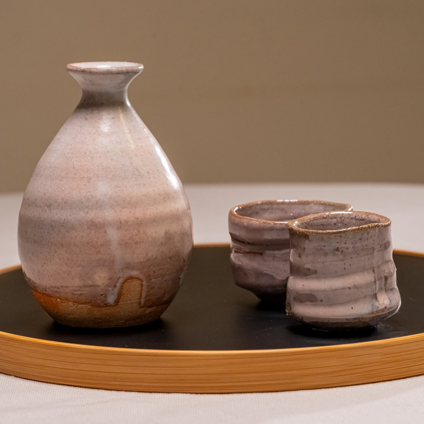 A Japanese ceramic sake set on a bamboo tray