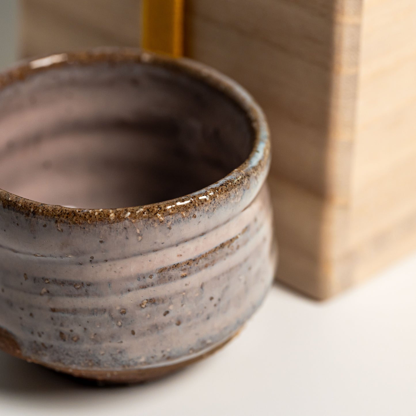 A pink Hagi yaki sake cup on a white background