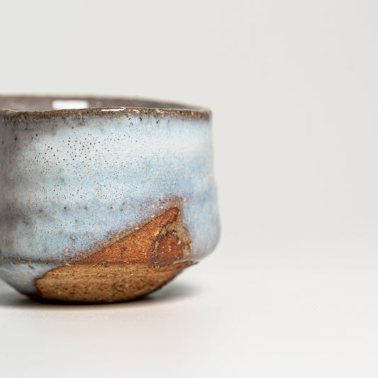 A blue and white Hagi yaki sake cup on a white background