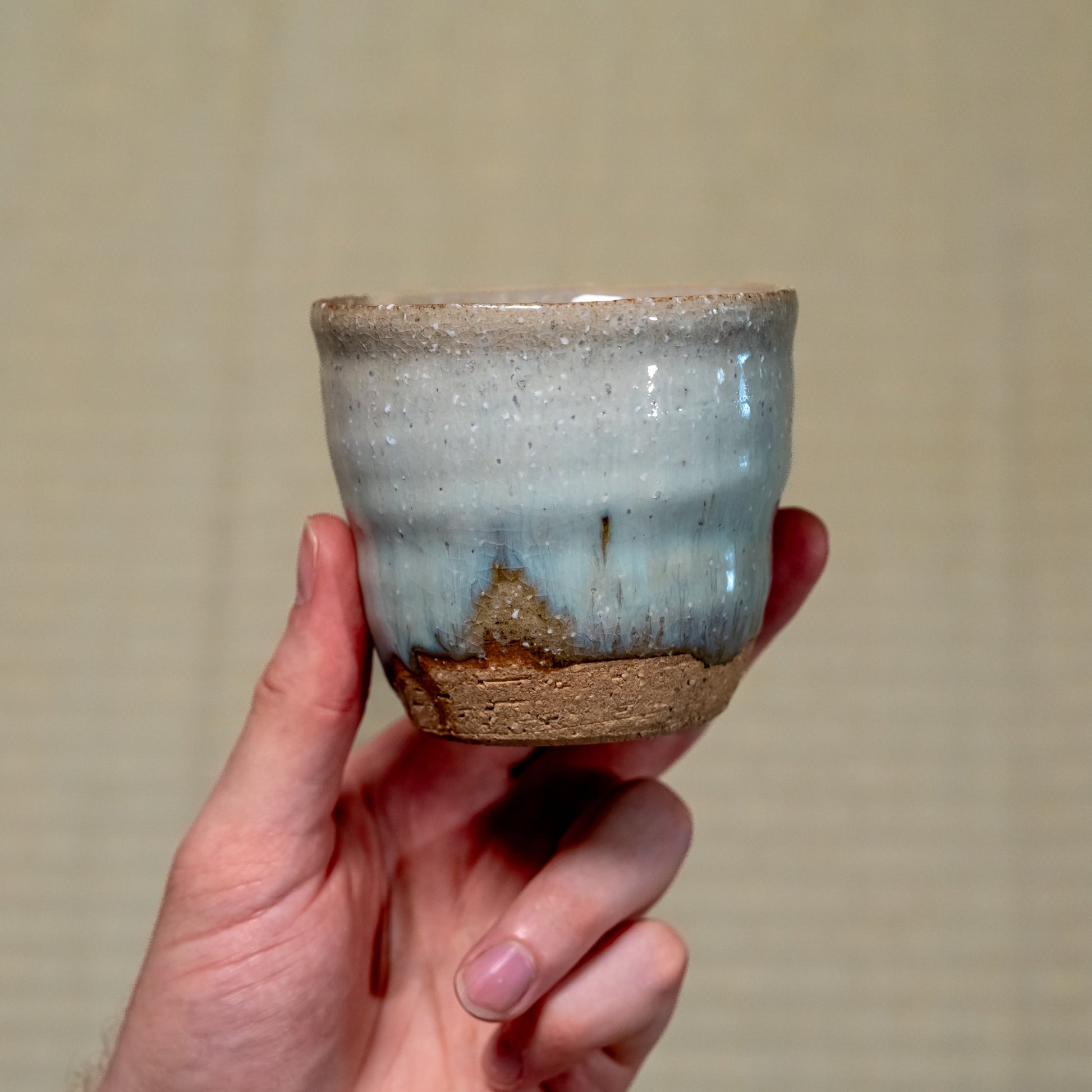 A Japanese ceramic Hagi yaki cup held in hand