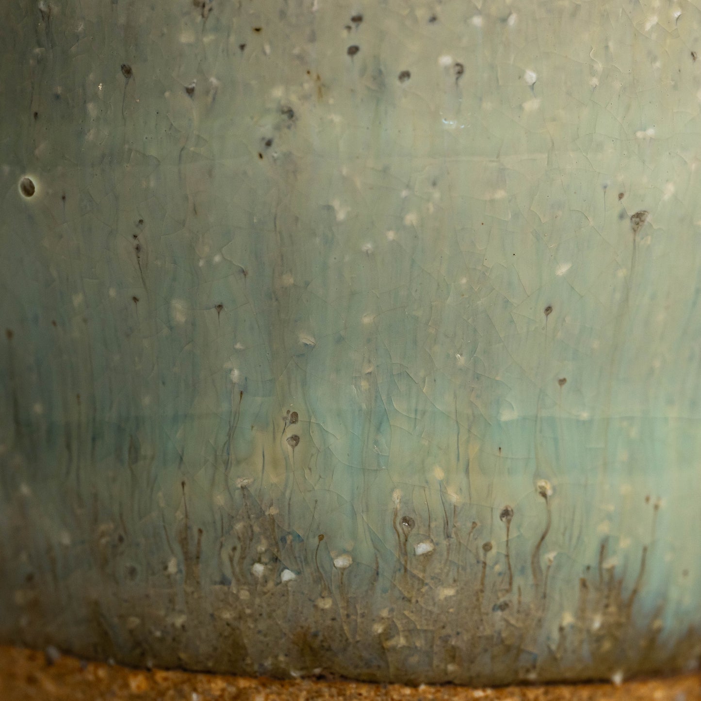 A close up of a green Hagi yaki shochu cup's glaze
