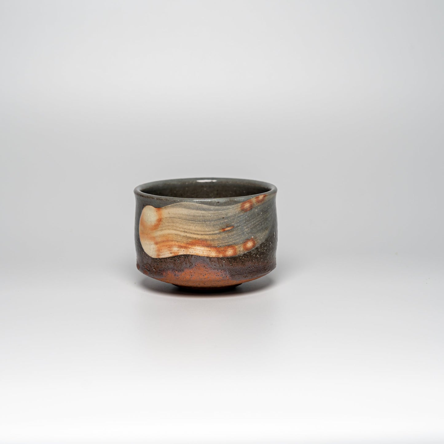 A brushed Hagi yaki cup on a white background
