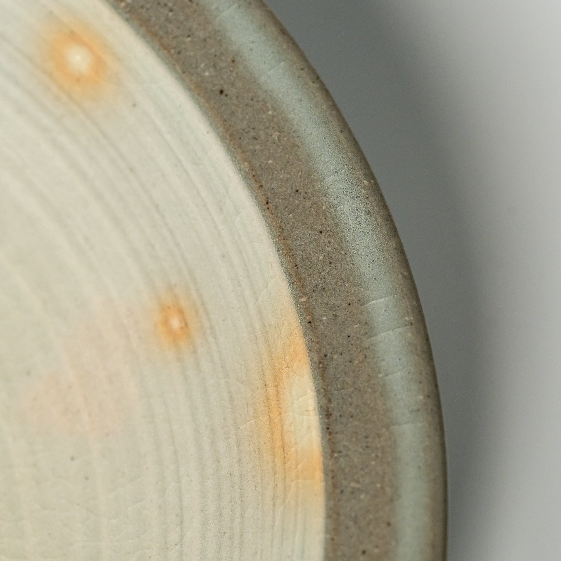 A close up of a Hagi yaki plate on a white background