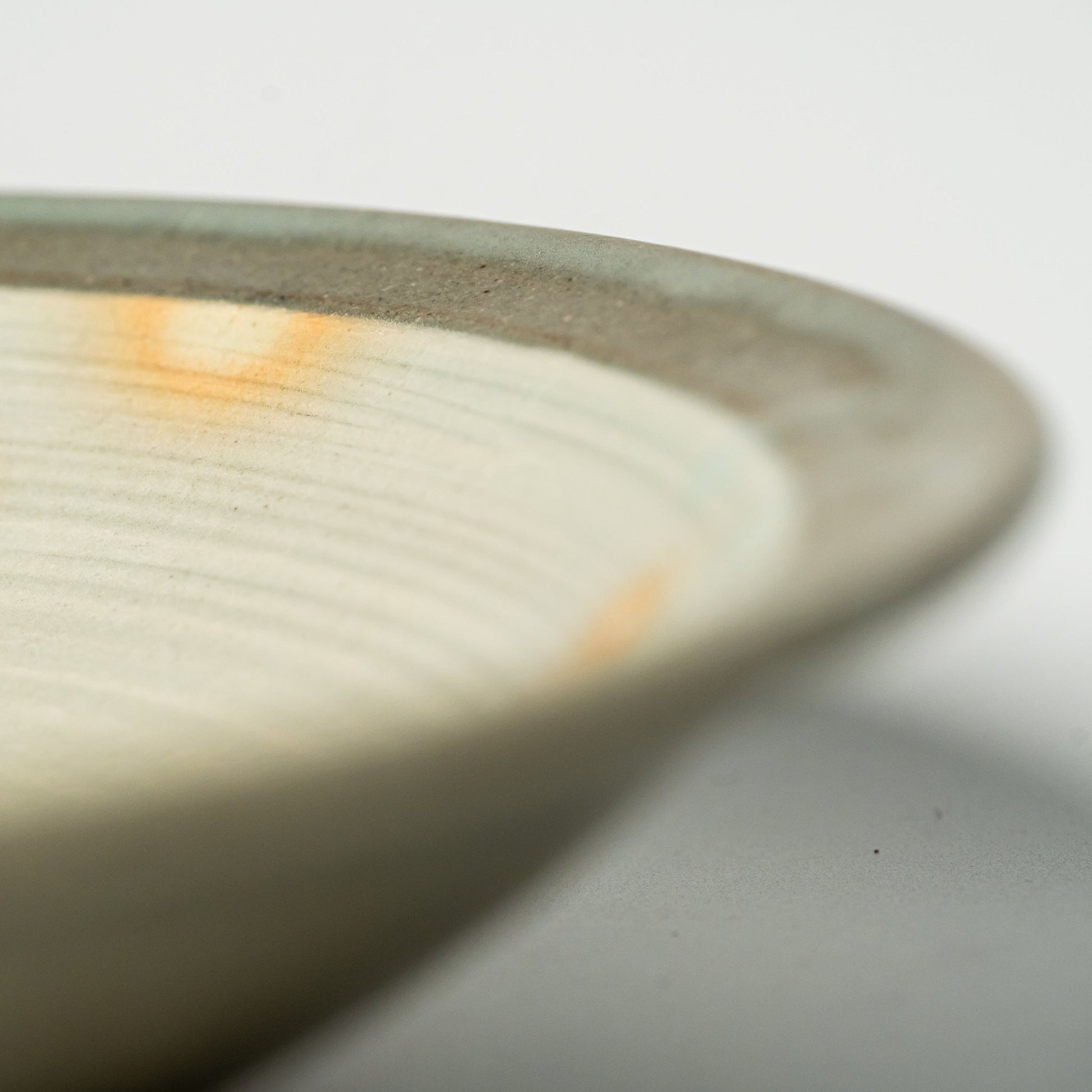 A close up of a Hagi yaki plate on a white background