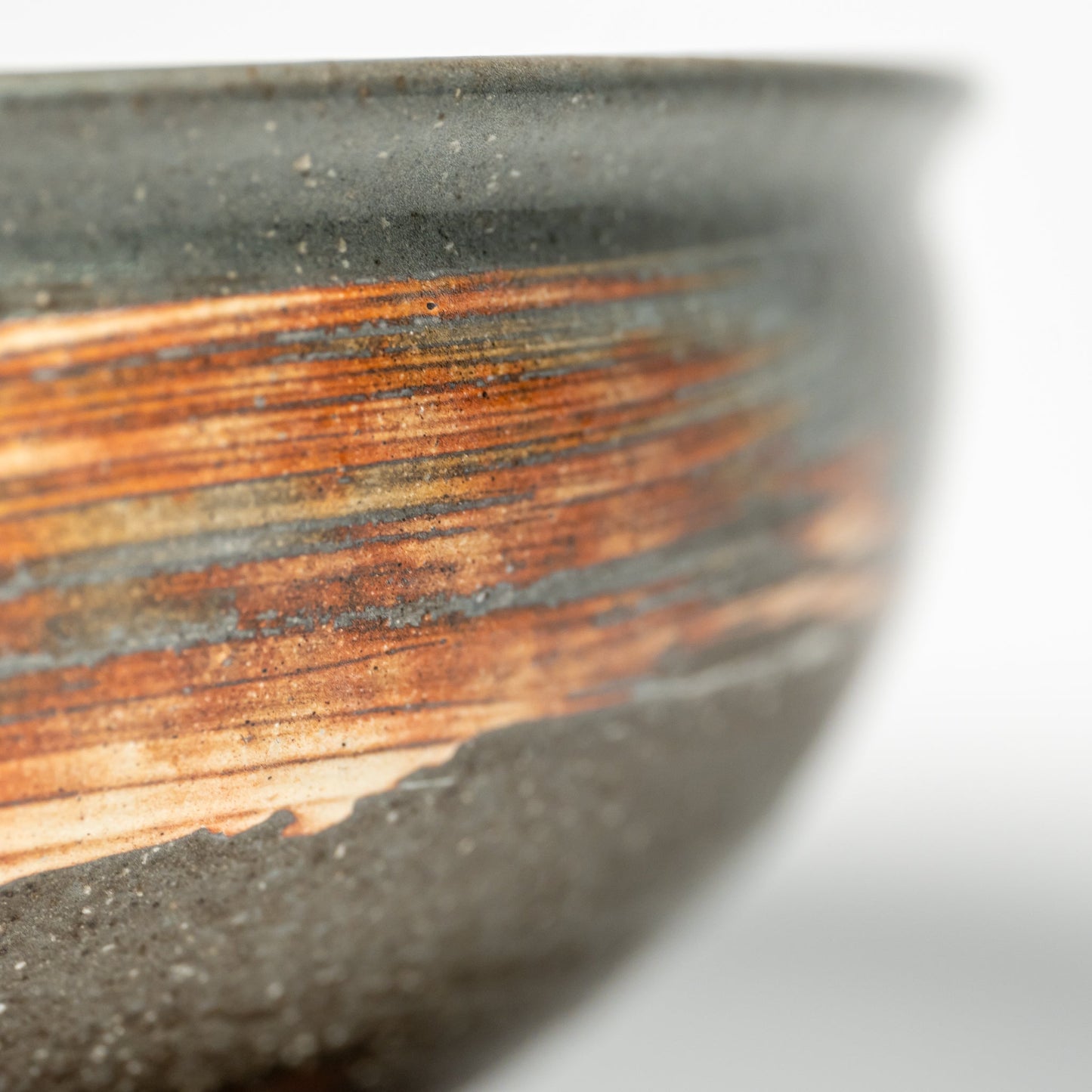 A close up of a Hagi yaki ramen bowl on a white background