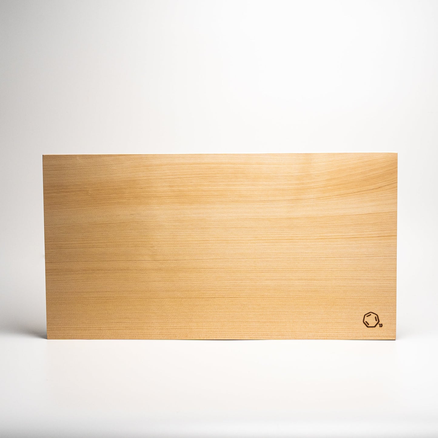 Large Cul de Sac hiba wood chopping board on a white background
