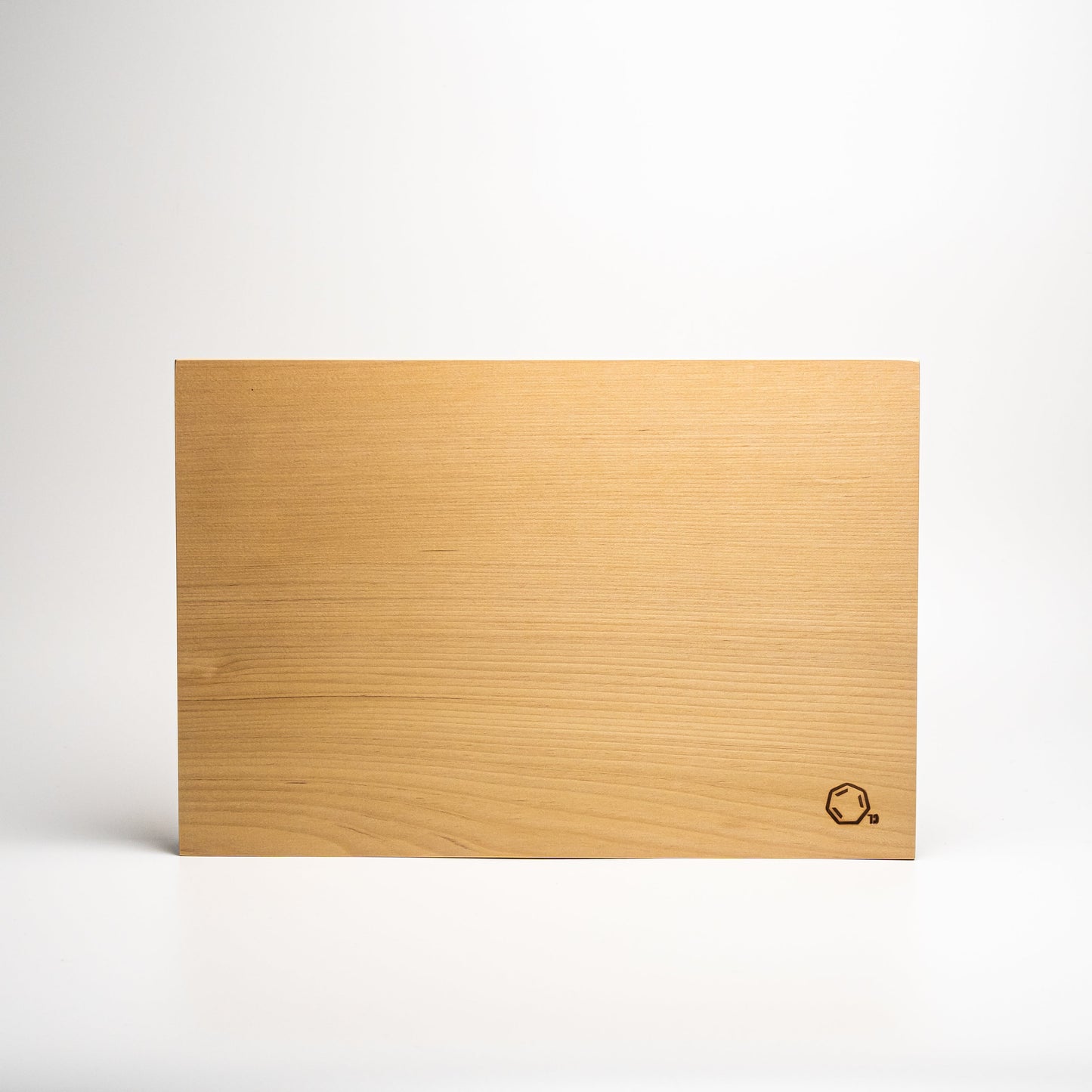 Small Cul de Sac hiba wood chopping board on a white background