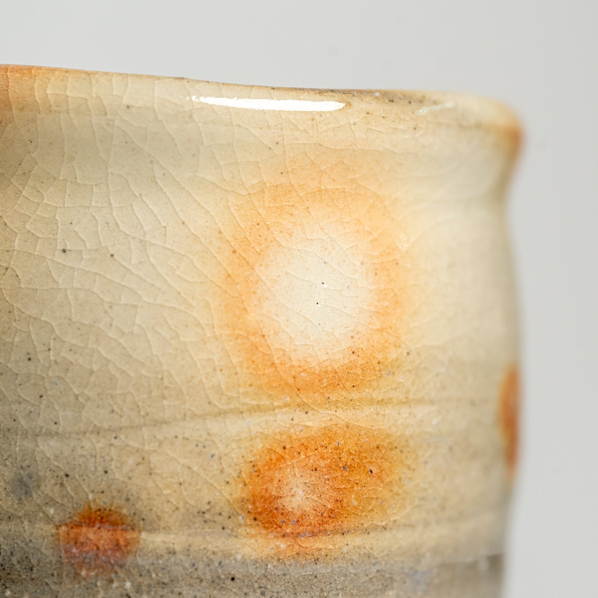 A close up of a kesho Hagi yaki teacup on a white background