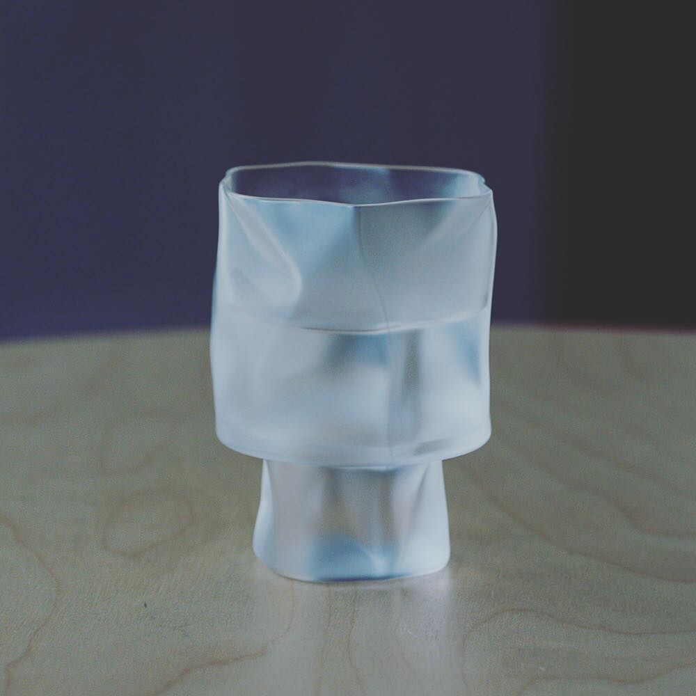 A frosted crumple cocktail glass on a wooden table