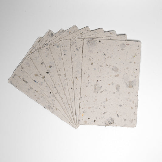 A fan of Awagami Factory recycled washi paper cards on a white background