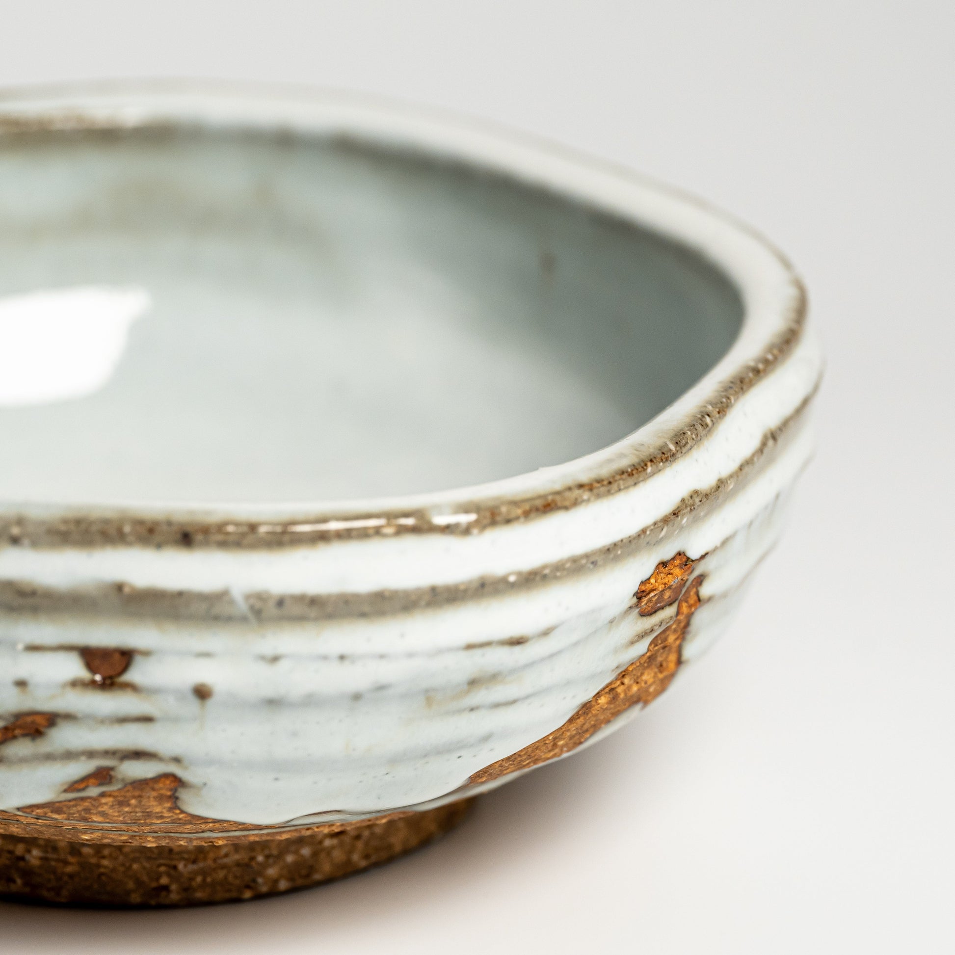 A close up of a white Hagi yaki bowl on a white background