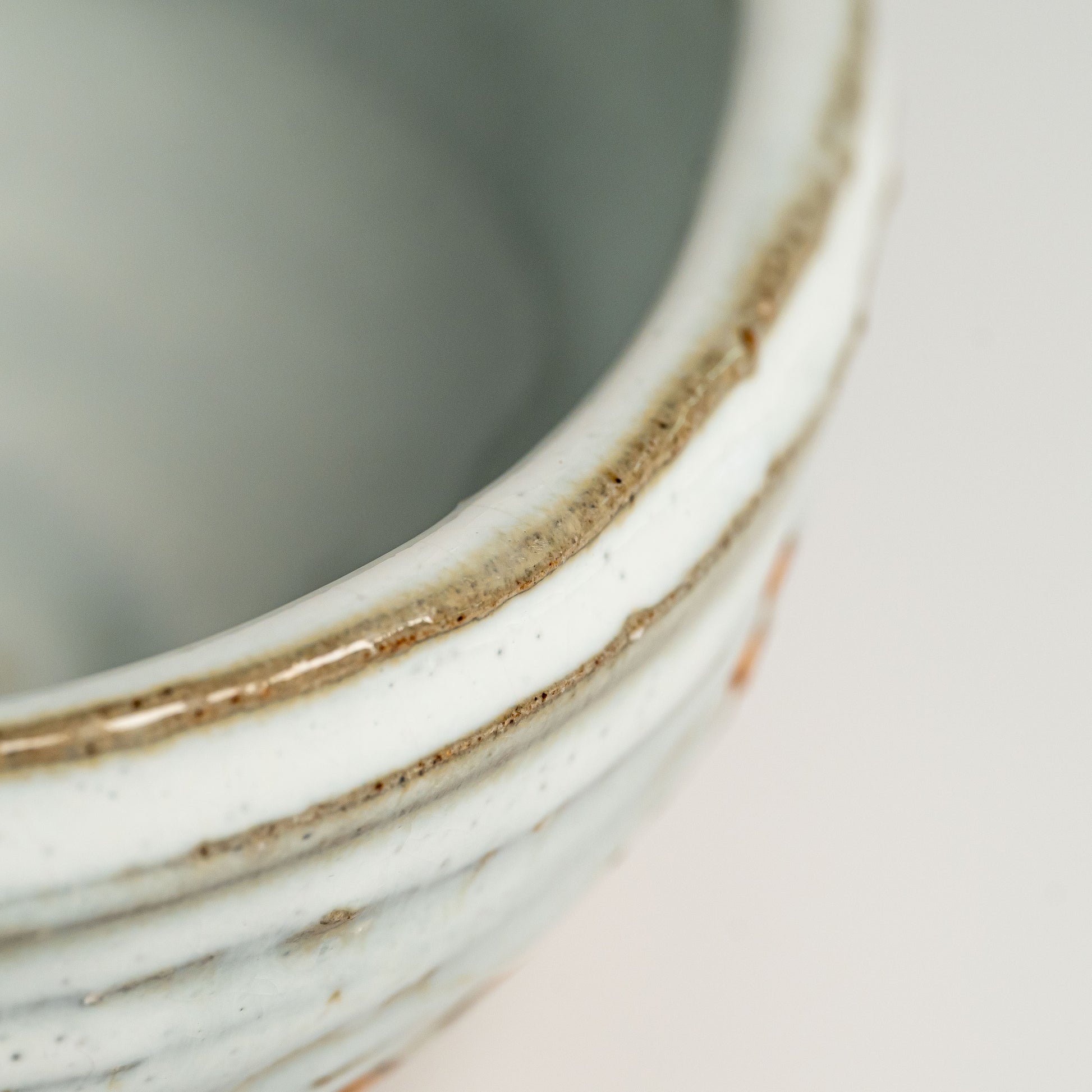 A close up of a white Hagi yaki bowl on a white background
