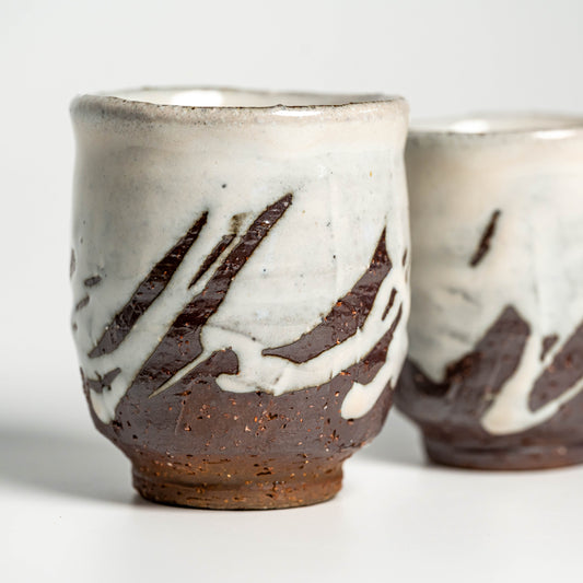A close up of white Hagi yaki teacups on a white background