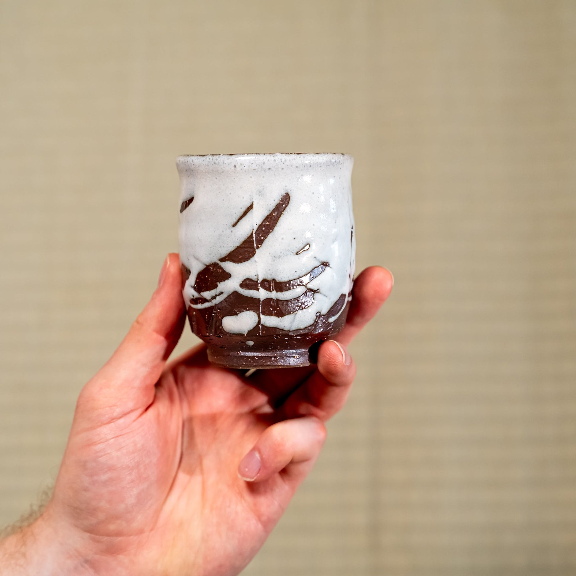 A Japanese ceramic Hagi yaki teacup held in hand