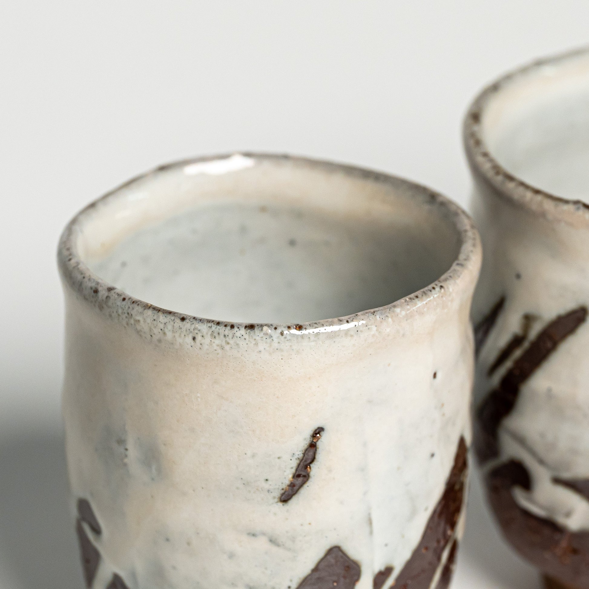 A close up of white Hagi yaki teacups on a white background