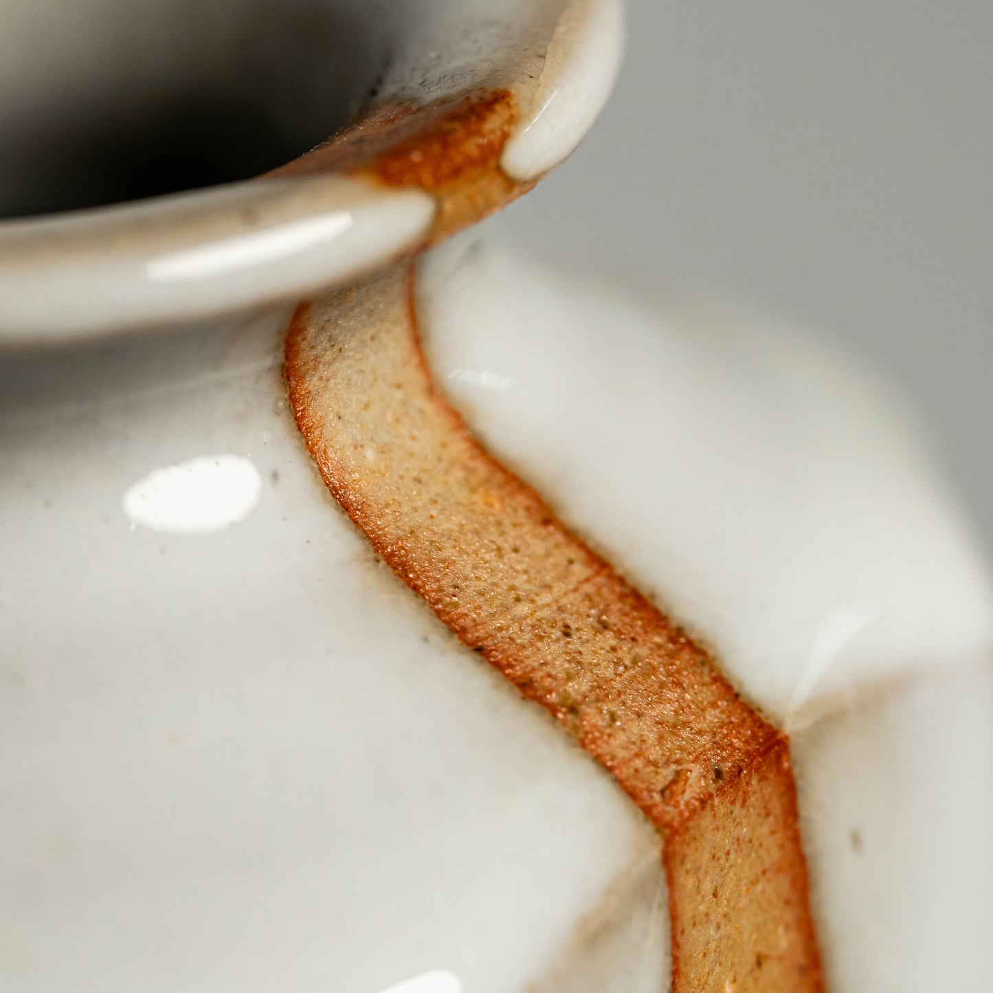 A close up of a white Hagi yaki vase