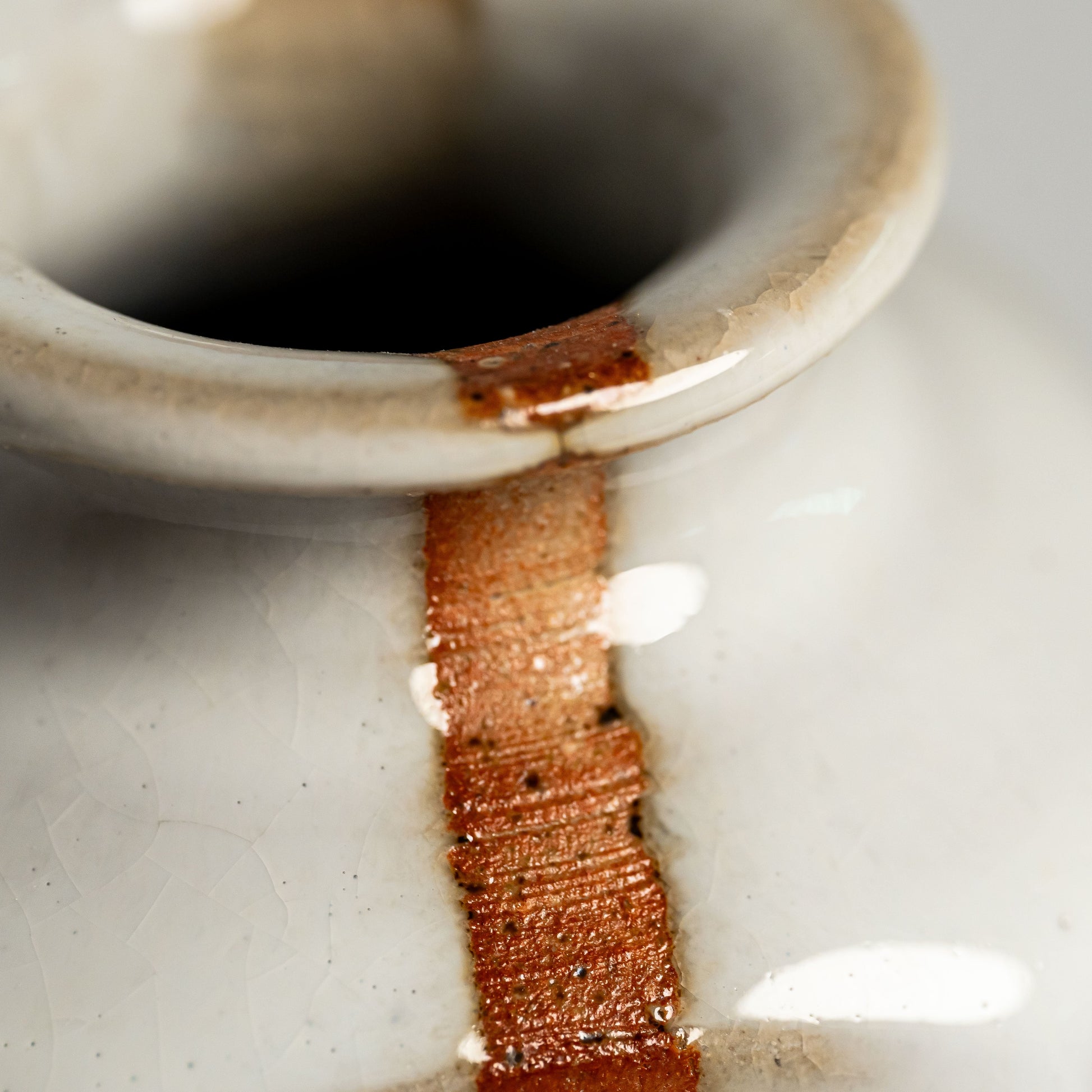 A close up of a white Hagi yaki vase