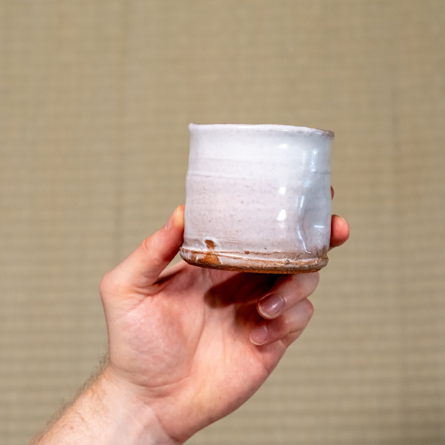 A Japanese ceramic Hagi yaki cup held in hand
