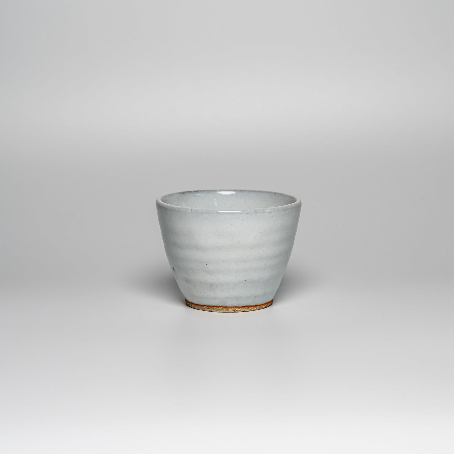 A white Hagi yaki teacup on a white background