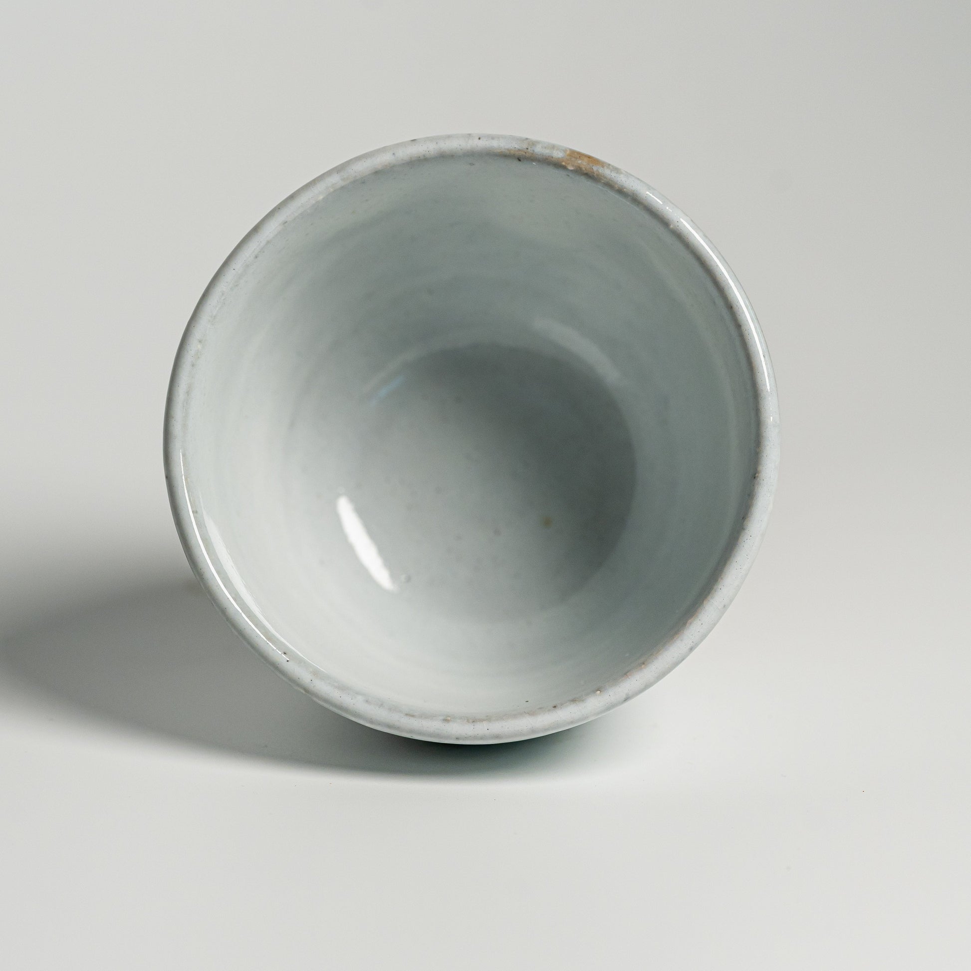 A white Hagi yaki teacup on a white background