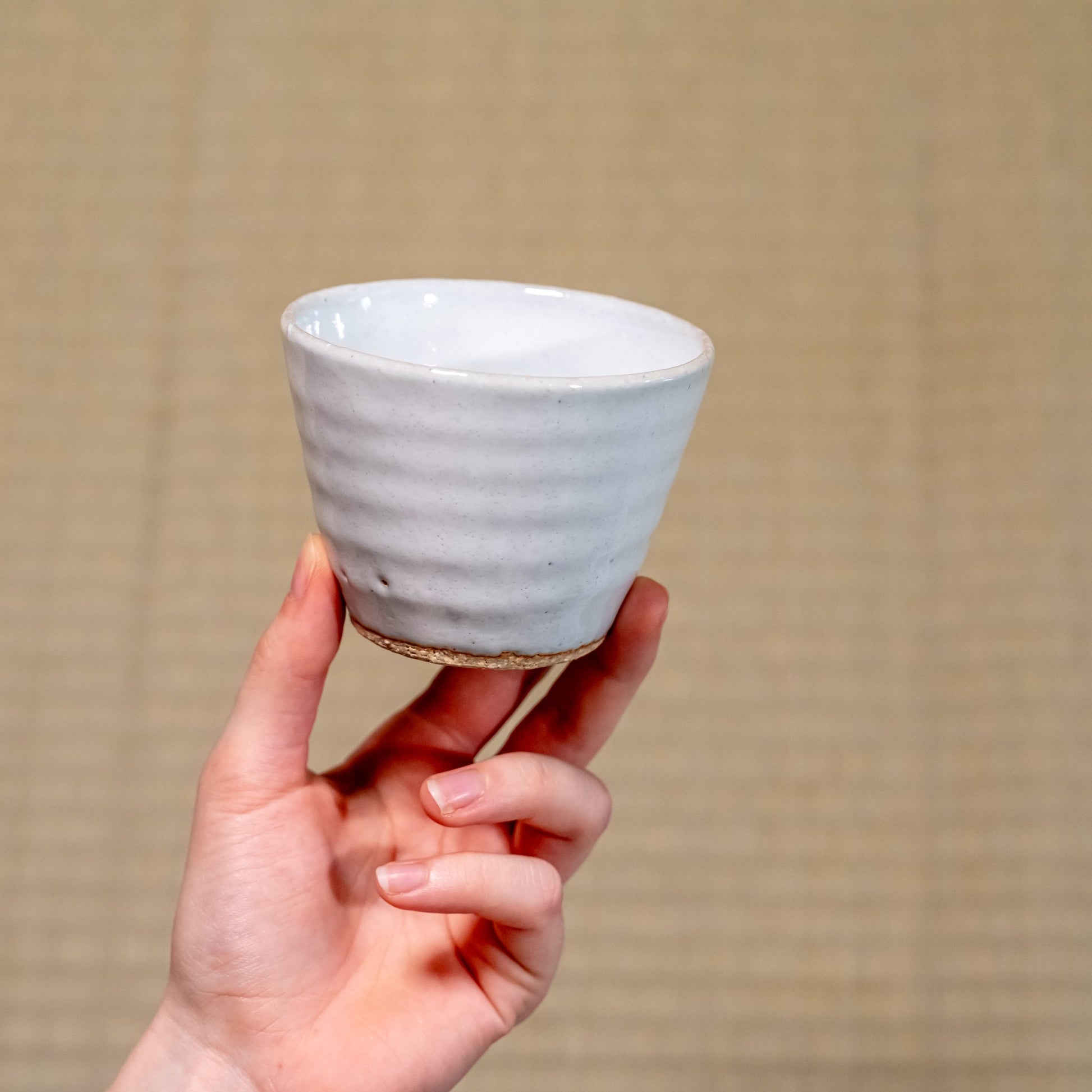 A Japanese ceramic Hagi yaki teacup held in hand