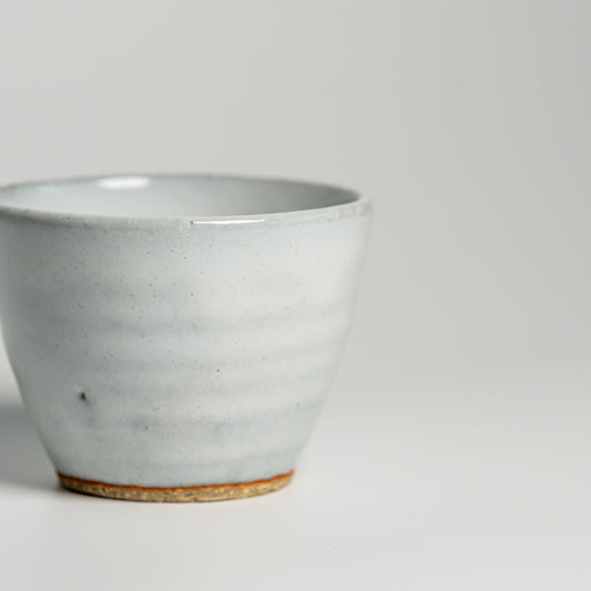 A white Hagi yaki teacup on a white background
