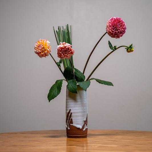 A Japanese ceramic vase with an ikebana inspired flower arrangement