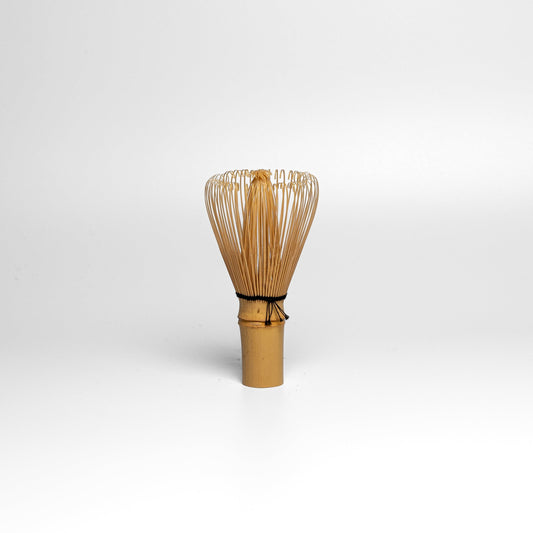 A white bamboo Takayama Chasen matcha whisk on a white background