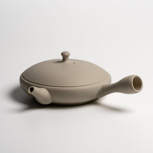 A Japanese ceramic teapot on a white background