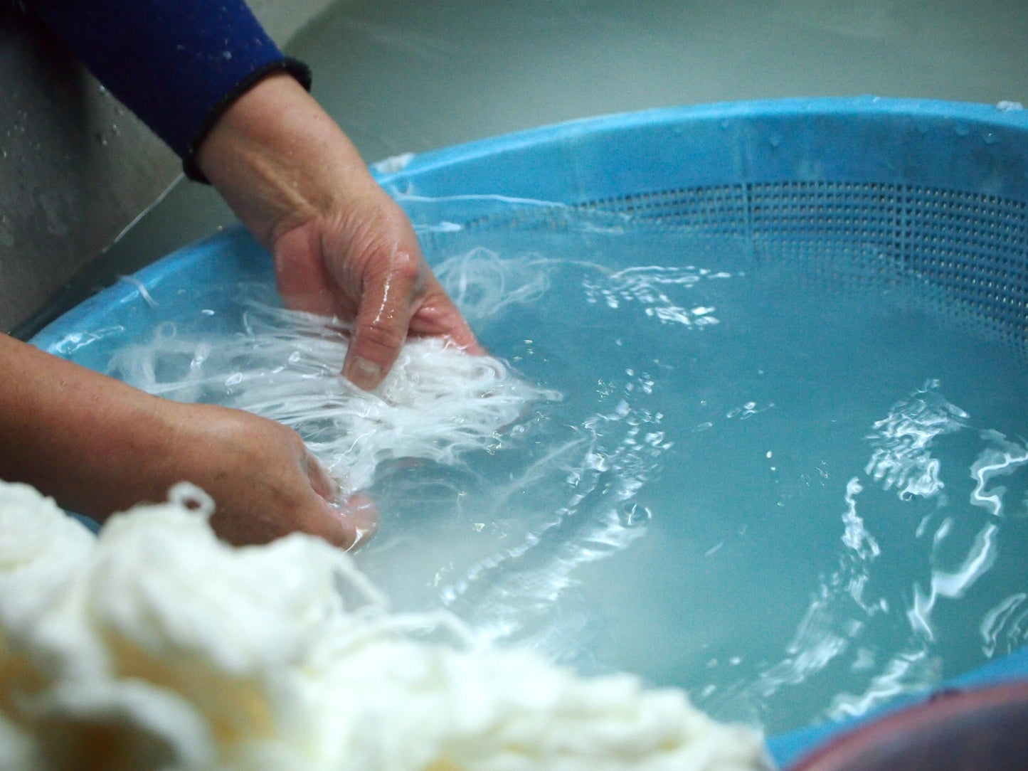 Awagami Factory artisan washing kozo fibres in water