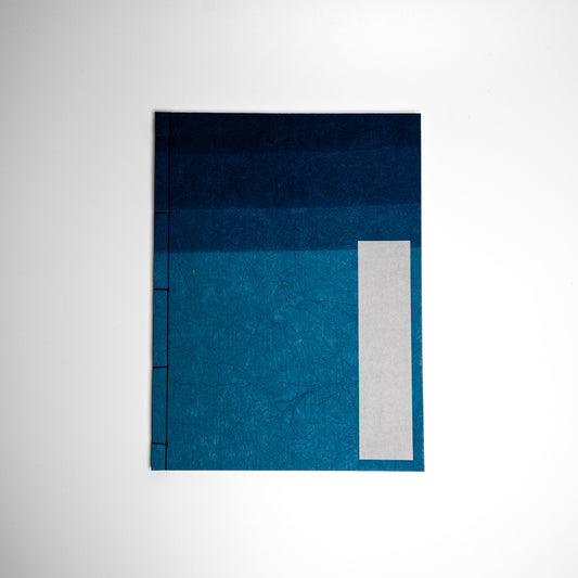 An Indigo Awagami Factory washi paper Watoji Notebook on a white background