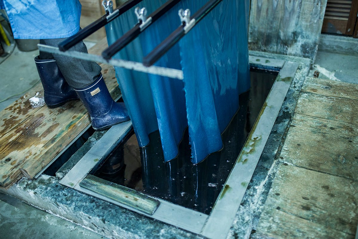 Awagami Factory washi paper notebook cover being dyed with indigo